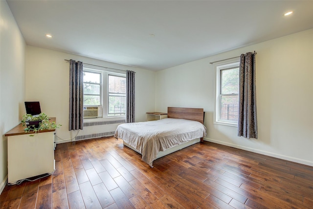 111-39 76th Rd Unit E2, Forest Hills, NY 11375 - bedroom with radiator heating unit, multiple windows, hardwood / wood-style flooring, and recessed lighting