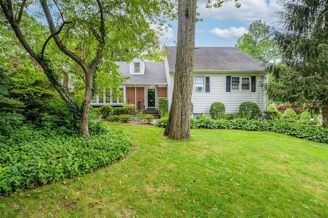 9 Martin Rd, Yonkers, NY 10701 - view of front facade with a front lawn, a shingled roof, and brick siding