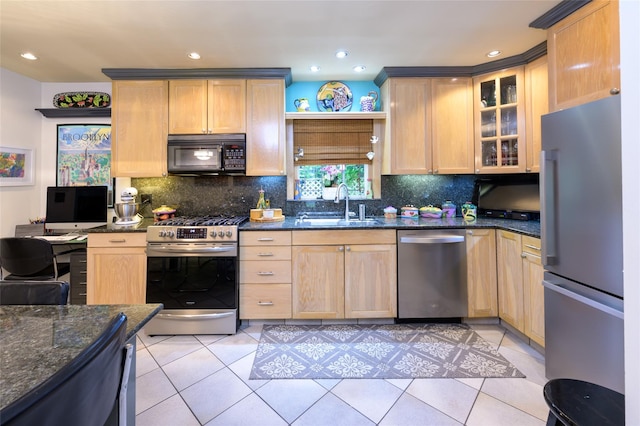 9 Martin Rd, Yonkers, NY 10701 - kitchen featuring appliances with stainless steel finishes, dark stone countertops, backsplash, glass insert cabinets, and light tile patterned flooring