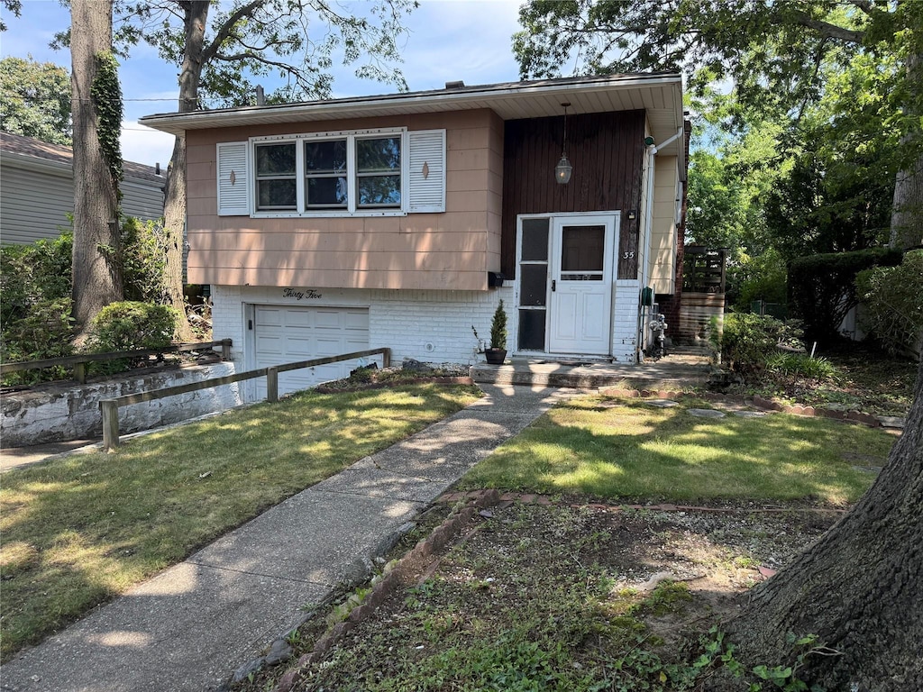35 E Walnut St, Massapequa, NY 11758 - bi-level home featuring a garage, a front yard, and brick siding