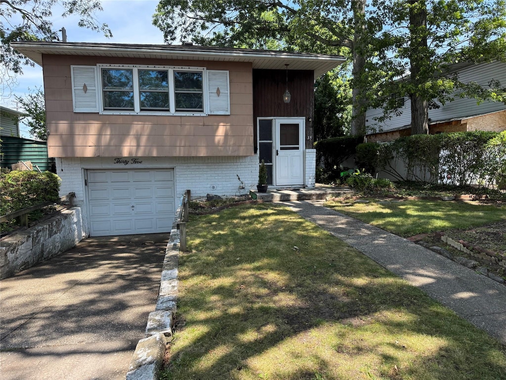 35 E Walnut St, Massapequa, NY 11758 - view of front of home with asphalt driveway, an attached garage, and a front yard