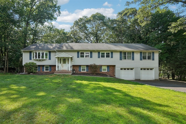 27A Claremont Ln, Suffern, NY 10901 - raised ranch with an attached garage, asphalt driveway, and a front lawn