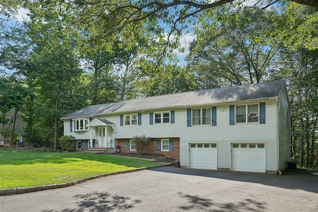 27A Claremont Ln, Suffern, NY 10901 - bi-level home with driveway, an attached garage, and a front lawn