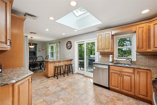 27A Claremont Ln, Suffern, NY 10901 - kitchen featuring stainless steel dishwasher, tasteful backsplash, a skylight, a breakfast bar, and recessed lighting