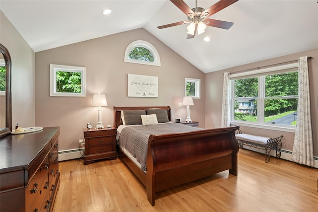 27A Claremont Ln, Suffern, NY 10901 - bedroom featuring a baseboard radiator, vaulted ceiling, light wood-style flooring, multiple windows, and ceiling fan