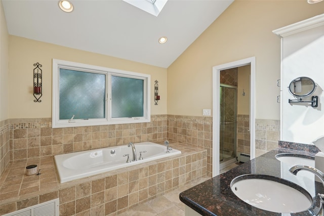 27A Claremont Ln, Suffern, NY 10901 - bathroom featuring lofted ceiling, a bath, double vanity, a skylight, and a baseboard heating unit