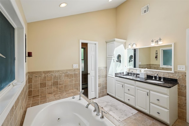 27A Claremont Ln, Suffern, NY 10901 - bathroom with a tub with jets, double vanity, and vaulted ceiling