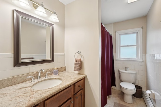 27A Claremont Ln, Suffern, NY 10901 - bathroom featuring a baseboard radiator, tile walls, vanity, wainscoting, and tile patterned flooring