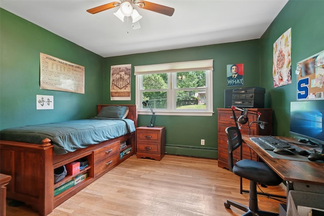 27A Claremont Ln, Suffern, NY 10901 - bedroom with a baseboard radiator, light wood-type flooring, a desk, and a ceiling fan