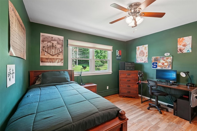 27A Claremont Ln, Suffern, NY 10901 - bedroom featuring baseboard heating, wood finished floors, an office area, and a ceiling fan