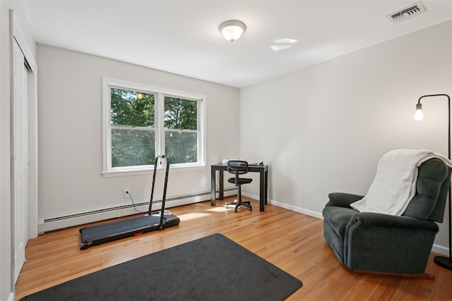 27A Claremont Ln, Suffern, NY 10901 - exercise area with a baseboard radiator and wood finished floors
