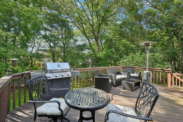 27A Claremont Ln, Suffern, NY 10901 - wooden deck featuring area for grilling, an outdoor living space, and view of wooded area