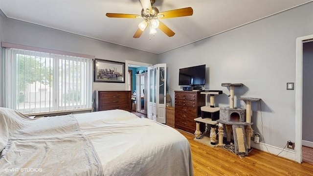 77-52 76th St, Glendale, NY 11385 - bedroom with wood finished floors and a ceiling fan