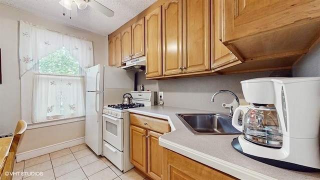 77-52 76th St, Glendale, NY 11385 - kitchen with white range with gas cooktop, under cabinet range hood, a ceiling fan, light tile patterned floors, and light countertops
