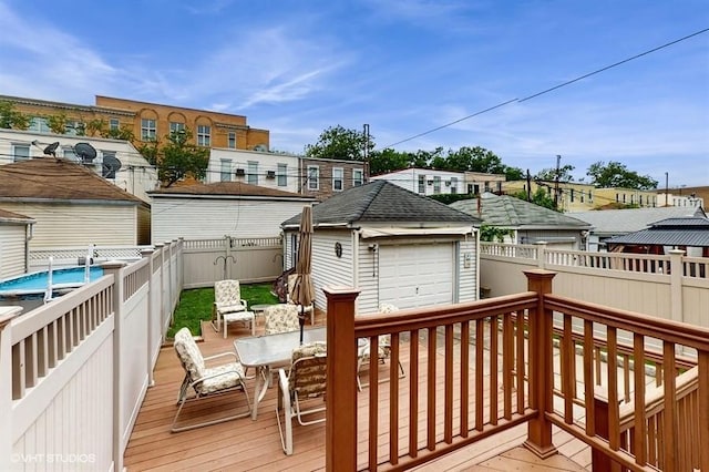 77-52 76th St, Glendale, NY 11385 - deck featuring a fenced backyard, outdoor dining space, and an outdoor structure
