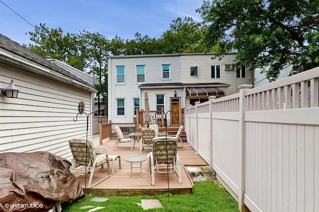 77-52 76th St, Glendale, NY 11385 - rear view of house with a wooden deck and outdoor dining space