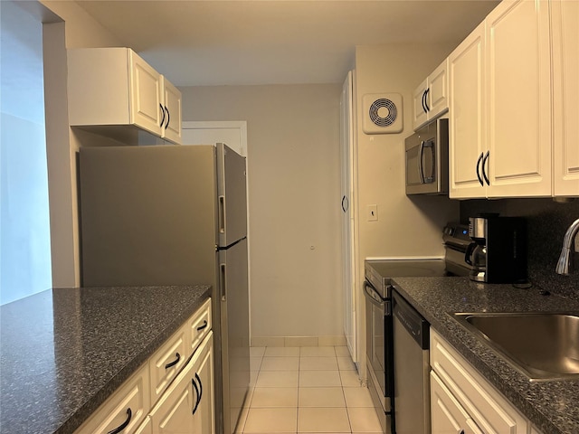 2355 Pershing Blvd Unit 707, Baldwin, NY 11510 - kitchen with appliances with stainless steel finishes, light tile patterned floors, white cabinets, and dark stone counters