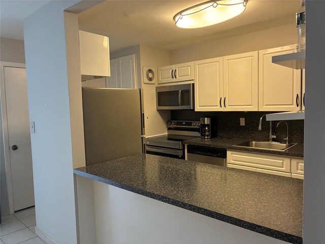 2355 Pershing Blvd Unit 707, Baldwin, NY 11510 - kitchen with appliances with stainless steel finishes, white cabinetry, and light tile patterned floors