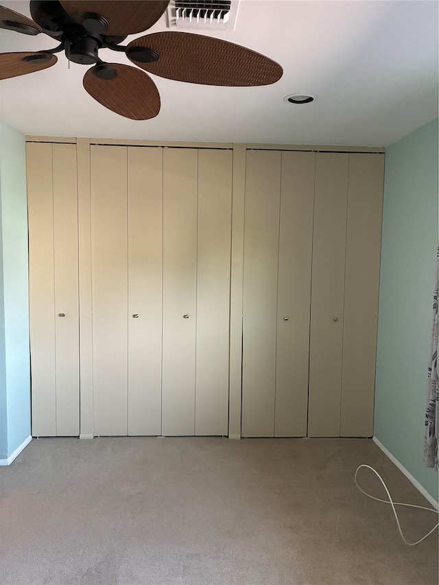 2355 Pershing Blvd Unit 707, Baldwin, NY 11510 - unfurnished bedroom with light colored carpet, two closets, and a ceiling fan