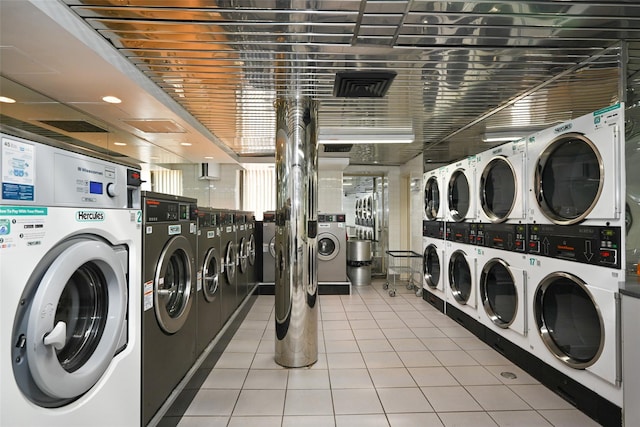 87-10 51st Ave Unit 6W, Elmhurst, NY 11373 - shared laundry with estacked washer and dryer, light tile patterned floors, and separate washer and dryer