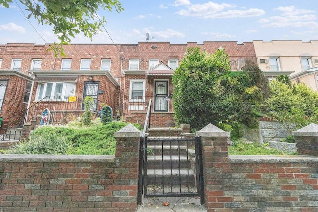 2117 38th St, Astoria, NY 11105 - multi unit property featuring a fenced front yard, a gate, and brick siding