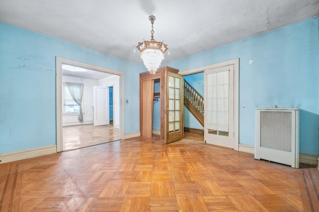 2117 38th St, Astoria, NY 11105 - unfurnished dining area featuring a chandelier, french doors, radiator heating unit, and stairs