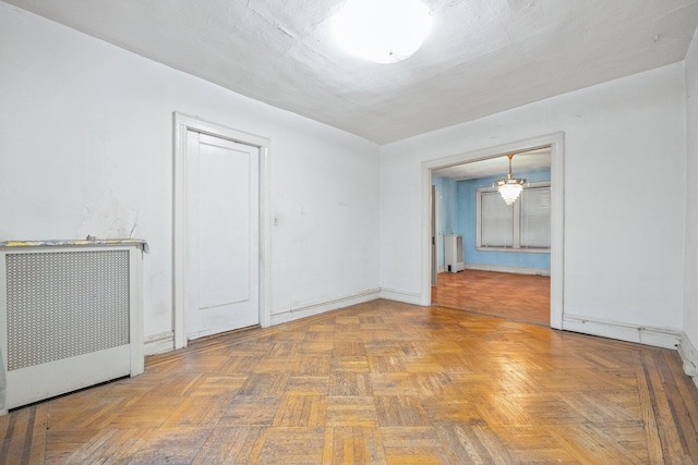 2117 38th St, Astoria, NY 11105 - empty room featuring radiator heating unit