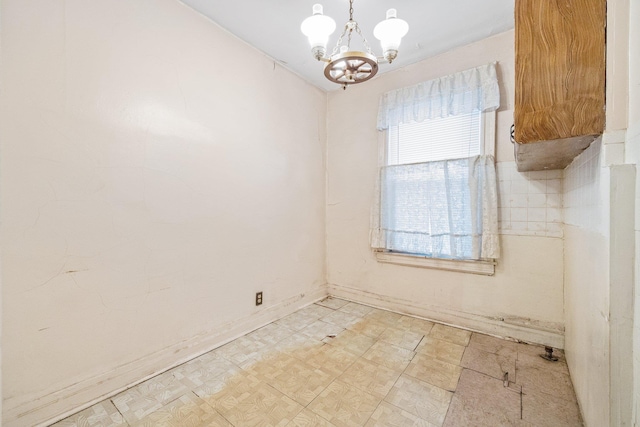 2117 38th St, Astoria, NY 11105 - spare room featuring a chandelier and light flooring