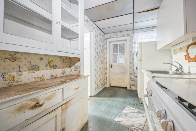 2117 38th St, Astoria, NY 11105 - kitchen featuring wallpapered walls, electric range, and light countertops