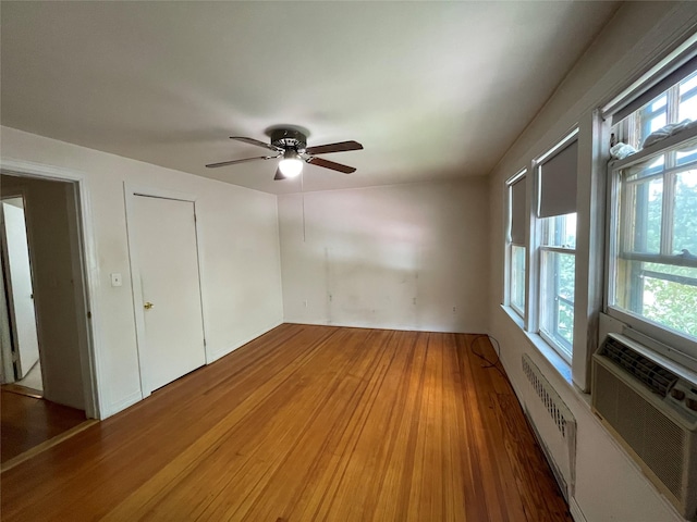 384 Hawthorne Ave, Yonkers, NY 10705 - unfurnished bedroom featuring light wood-style floors, multiple windows, and a ceiling fan