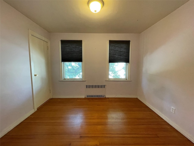 384 Hawthorne Ave, Yonkers, NY 10705 - empty room featuring radiator heating unit and wood finished floors