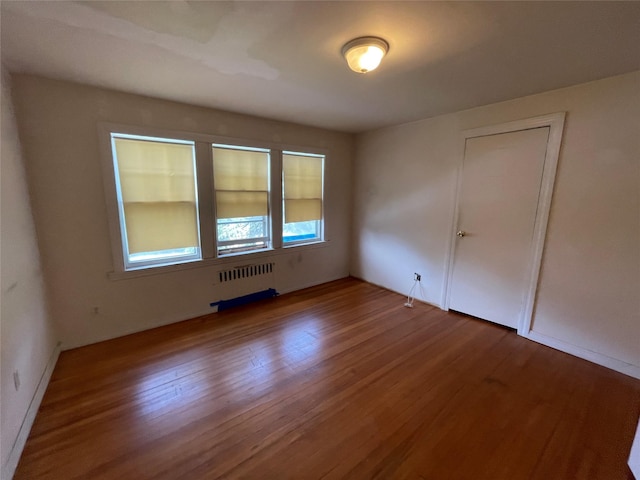 384 Hawthorne Ave, Yonkers, NY 10705 - spare room featuring radiator and wood finished floors