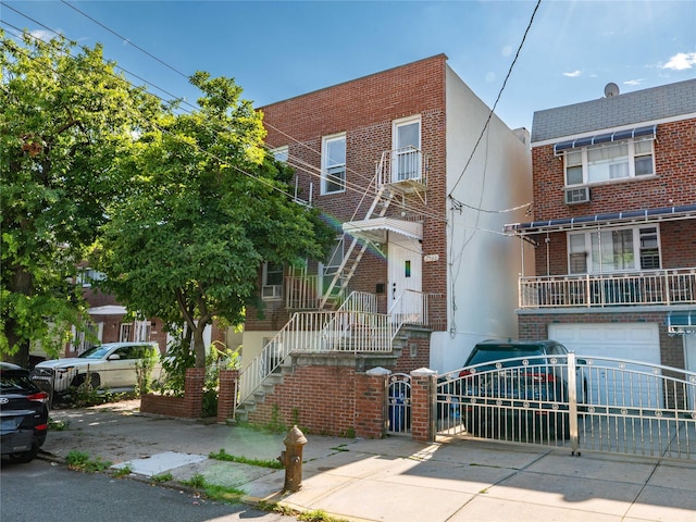2525 Radcliff Ave, Bronx, NY 10469 - multi unit property with brick siding, concrete driveway, a garage, stucco siding, and a gate