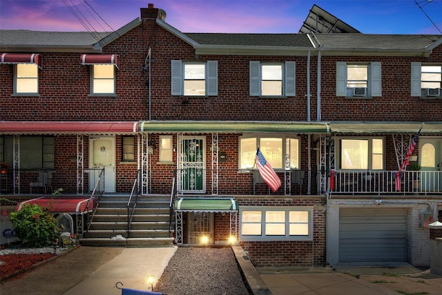 1004 Balcom Ave, Bronx, NY 10465 - view of property with brick siding, cooling unit, and a garage