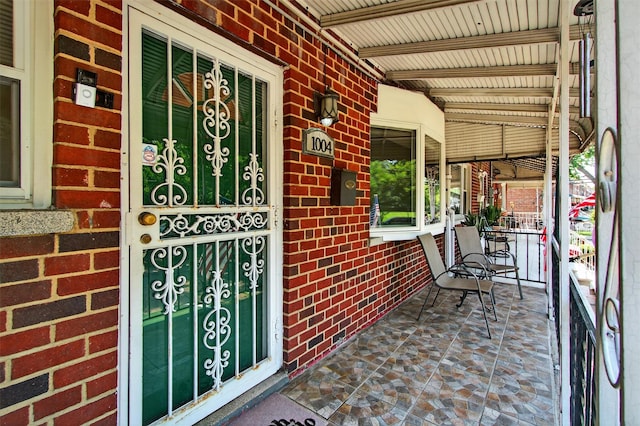 1004 Balcom Ave, Bronx, NY 10465 - doorway to property featuring a porch and brick siding