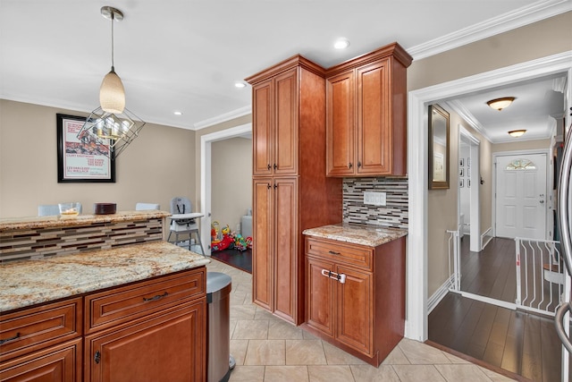 1004 Balcom Ave, Bronx, NY 10465 - kitchen featuring ornamental molding, brown cabinets, tasteful backsplash, light stone countertops, and pendant lighting