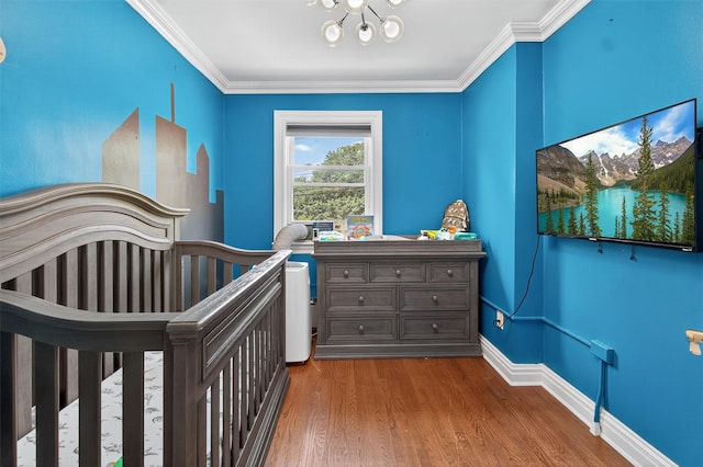1004 Balcom Ave, Bronx, NY 10465 - bedroom with wood finished floors, crown molding, a crib, and a chandelier