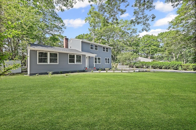 70 Robinson Ave, Brookhaven, NY 11763 - rear view of property with a lawn and a chimney