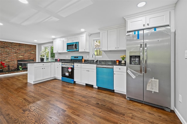 70 Robinson Ave, Brookhaven, NY 11763 - kitchen featuring appliances with stainless steel finishes, a peninsula, healthy amount of natural light, dark countertops, and recessed lighting
