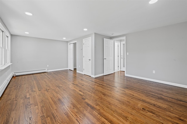 70 Robinson Ave, Brookhaven, NY 11763 - empty room with a baseboard radiator, recessed lighting, and dark wood-type flooring