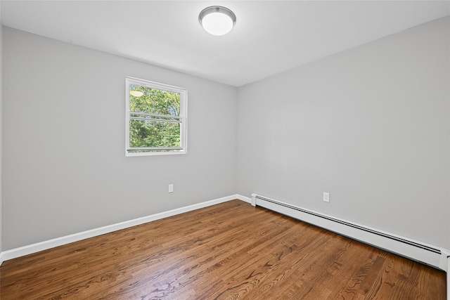 70 Robinson Ave, Brookhaven, NY 11763 - unfurnished room featuring baseboard heating and wood finished floors