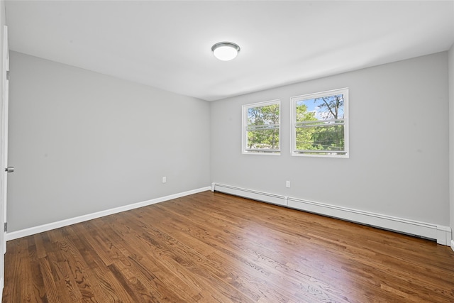 70 Robinson Ave, Brookhaven, NY 11763 - unfurnished room with a baseboard radiator and wood finished floors