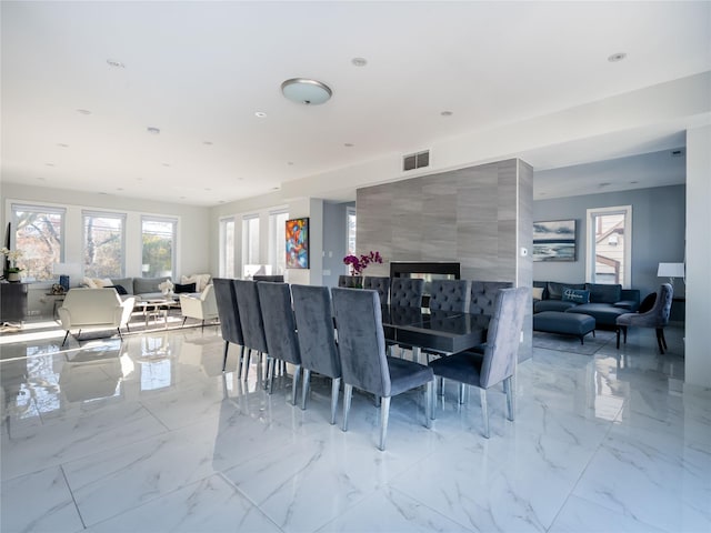 85 Erie Ave, Atlantic Beach, NY 11509 - dining space featuring light marble finish flooring, recessed lighting, and a fireplace