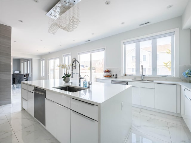 85 Erie Ave, Atlantic Beach, NY 11509 - kitchen featuring dishwasher, modern cabinets, light marble finish flooring, a kitchen island with sink, and recessed lighting