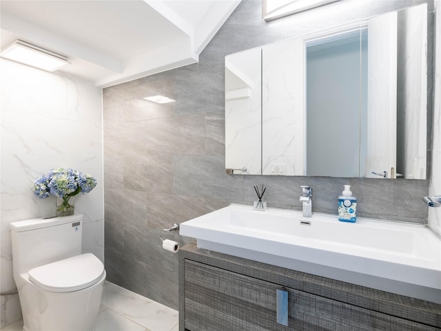 85 Erie Ave, Atlantic Beach, NY 11509 - bathroom featuring vanity, tile walls, and marble look tile flooring