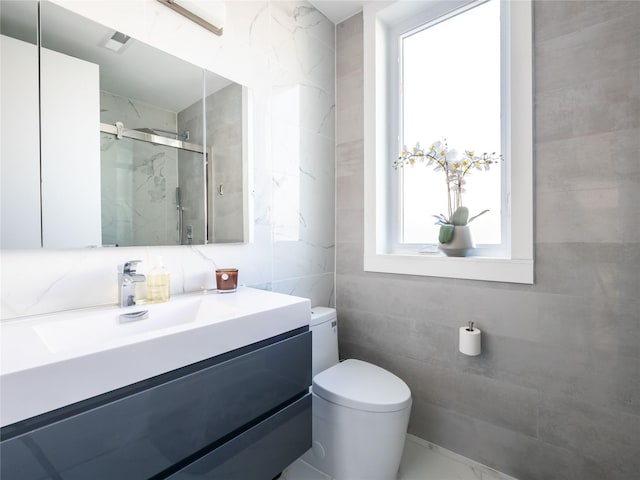85 Erie Ave, Atlantic Beach, NY 11509 - bathroom featuring tile walls, vanity, and a marble finish shower