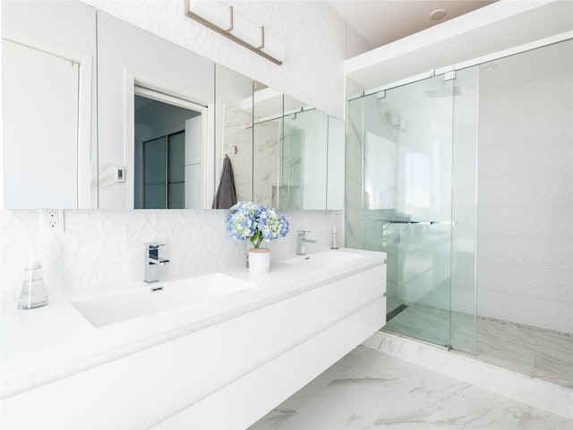 85 Erie Ave, Atlantic Beach, NY 11509 - full bathroom featuring a marble finish shower, double vanity, marble look tile flooring, and tasteful backsplash