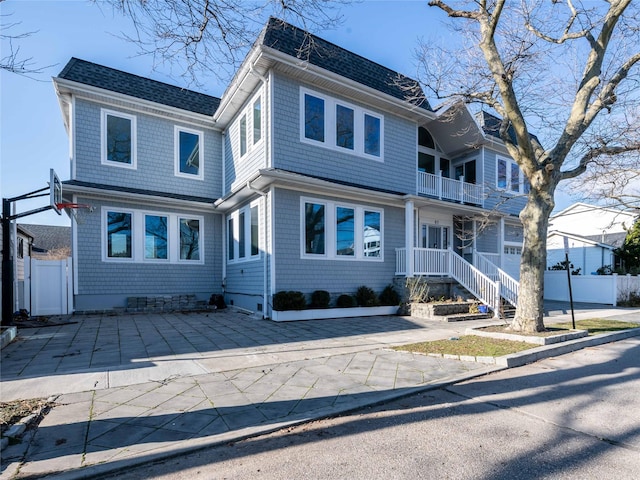 85 Erie Ave, Atlantic Beach, NY 11509 - view of front of house with a balcony and roof with shingles