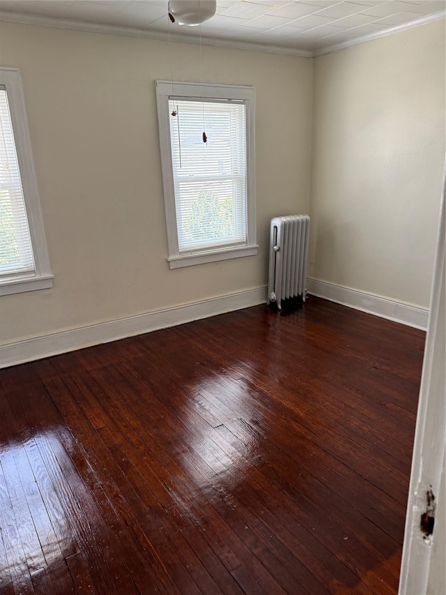 9030 202nd St, Hollis, NY 11423 - empty room with radiator heating unit, ornamental molding, and dark wood-style floors