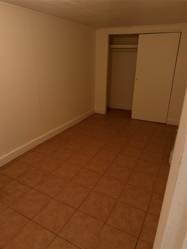 9030 202nd St, Hollis, NY 11423 - unfurnished bedroom featuring a closet and light tile patterned flooring